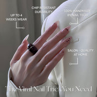 Glossy medium almond nails with nude base and tiny red hearts for a soft, romantic vibe.