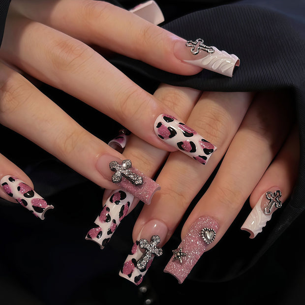Medium square pink leopard print press-on nails with glitter, chrome cross and heart charms, punk Y2K style