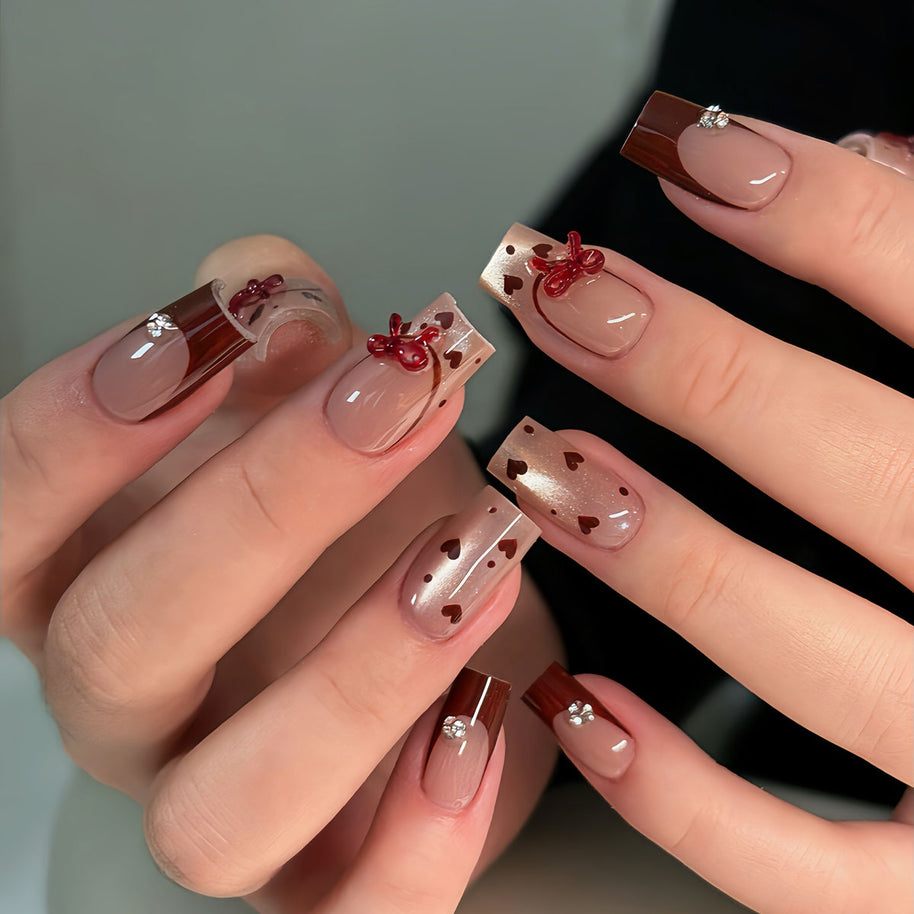 Glossy medium square nails | nude + burgundy tips + 3D red bows | sent with love