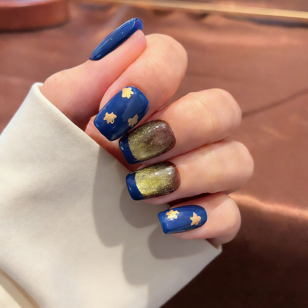 blue gold cat eye press on nails, gilded star accents fake nails, short square shape acrylic nails, festive luxury nail art, reusable edgy press on nails, new year party fake nails, 2026 trendy blue gold nails, women's bold fake nails