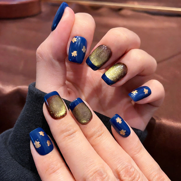 blue gold cat eye press on nails, gilded star accents fake nails, short square shape acrylic nails, festive luxury nail art, reusable edgy press on nails, new year party fake nails, 2026 trendy blue gold nails, women's bold fake nails