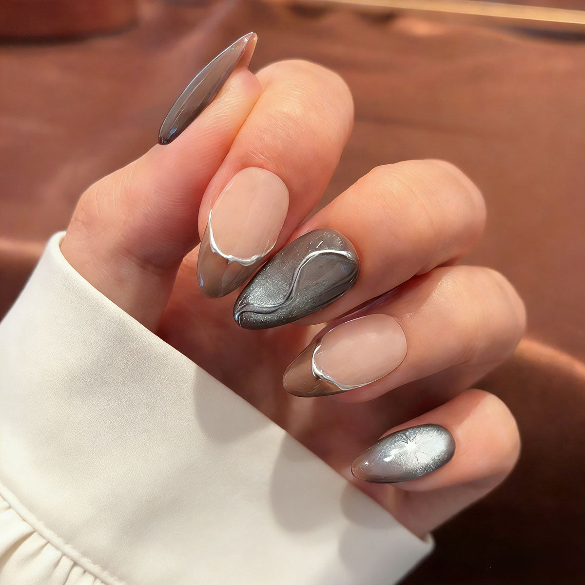 liquid metal silver cat eye press on nails, abstract wave fake nails, short almond shape acrylic nails, futuristic style nails, luxury handmade reusable nails, avant-garde nail art, women's daily wear fake nails, 2026 trendy futuristic nail