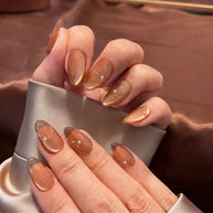 amber glow cat eye press on nails, gold line accents fake nails, short almond shape acrylic nails, romantic date nails, luxury handmade reusable nails, gentle daily wear nail art, women's office friendly fake nails, 2026 trendy amber nails