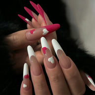 Glossy extra-long stiletto nails with nude gradient base, white French tips, and dual-tone hearts for a sweet, romantic vibe.