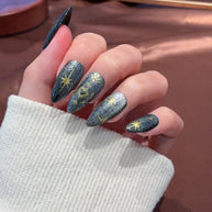 black gold glitter press on nails, celestial sun moon star fake nails, stiletto shape acrylic nails, gothic luxury reusable nails, Halloween party festival nails, 3D gold totem nail art, edgy daily wear fake nails, 2026 trendy gothic nails