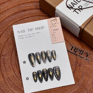 black gold glitter press on nails, celestial sun moon star fake nails, stiletto shape acrylic nails, gothic luxury reusable nails, Halloween party festival nails, 3D gold totem nail art, edgy daily wear fake nails, 2026 trendy gothic nails