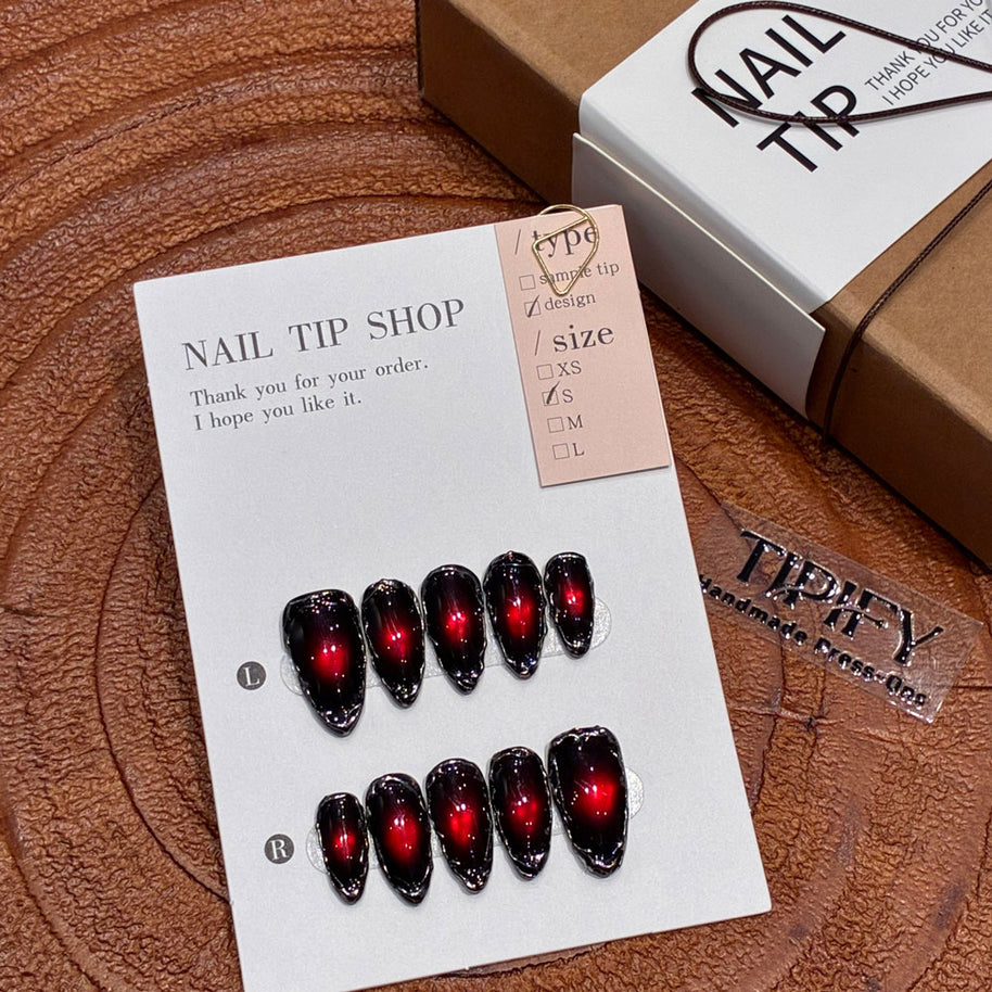 Gothic vampire-inspired nails featuring dramatic red-black gradient and glass-like black trim