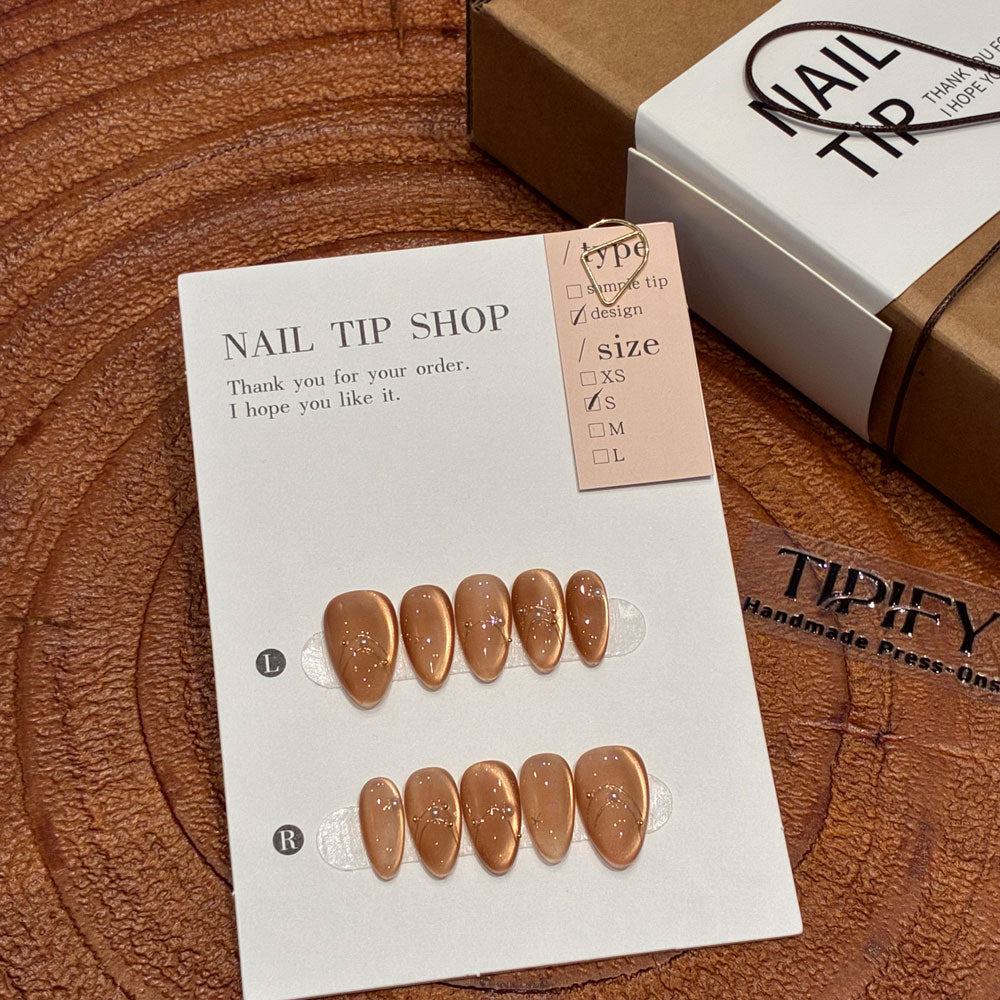 amber glow cat eye press on nails, gold line accents fake nails, short almond shape acrylic nails, romantic date nails, luxury handmade reusable nails, gentle daily wear nail art, women's office friendly fake nails, 2026 trendy amber nails