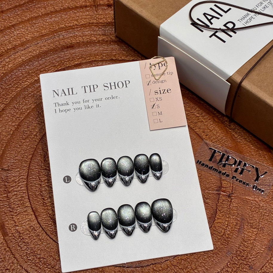 void edge cat eye press on nails, black silver marble swirl fake nails, short almond shape acrylic nails, minimalist goth nails, reusable edgy press on nails, 2026 trendy black silver nails, women's party fake nails, glitter cat eye short almond nails