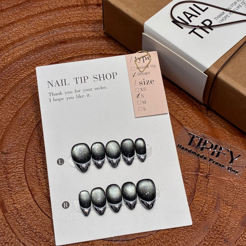 void edge cat eye press on nails, black silver marble swirl fake nails, short almond shape acrylic nails, minimalist goth nails, reusable edgy press on nails, 2026 trendy black silver nails, women's party fake nails, glitter cat eye short almond nails