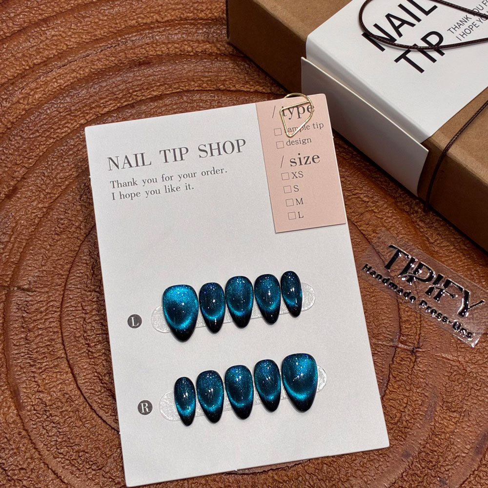 stellar blue cat eye press on nails, blue glitter gradient fake nails, short almond shape acrylic nails, cosmic starry sky nail art, reusable edgy wear nails, festival party cat eye nails, 2026 trendy blue nails, women's daily cool fake nails