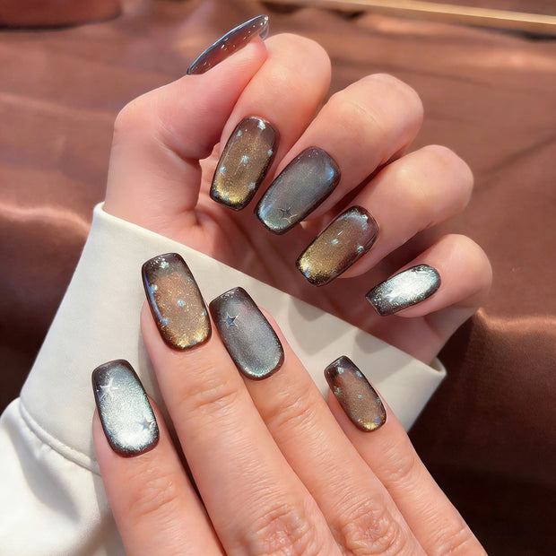 Bronze Lumina cat eye press-on nails with holographic glitter and starburst details