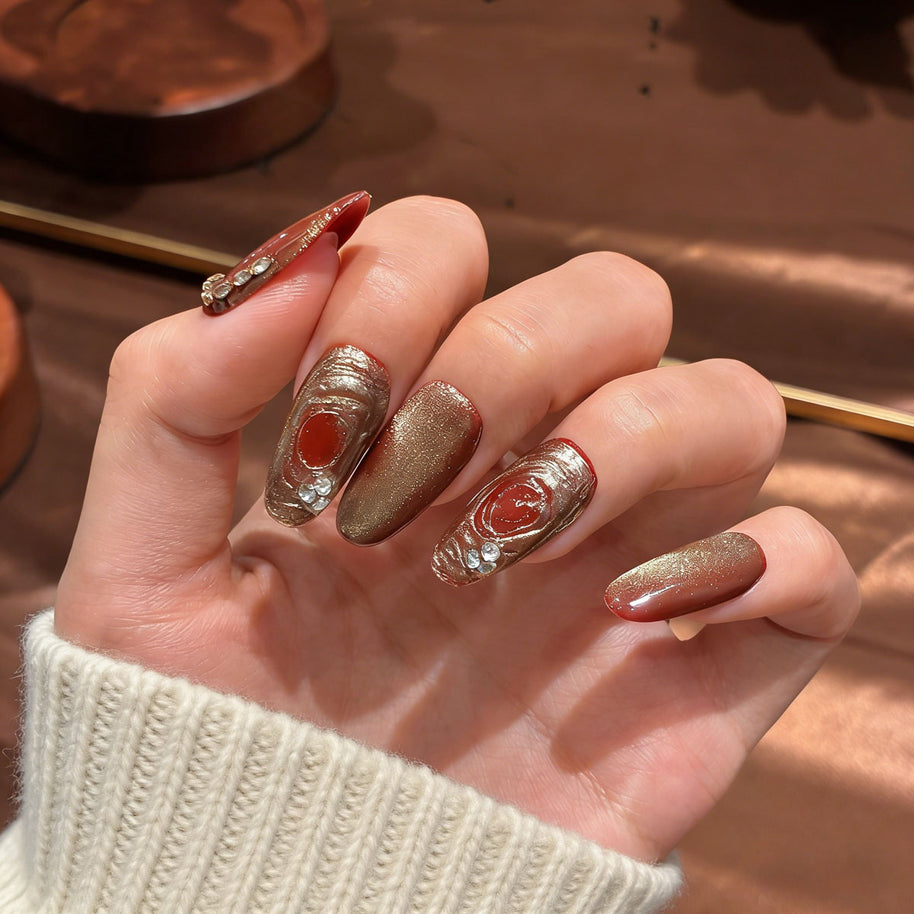 red gold cat eye press on nails, gilded swirl fake nails, medium almond shape acrylic nails, festive wedding nails, luxury handmade reusable nails, rhinestone accent nail art, 2026 Chinese New Year nails, women's daily wear fake nails