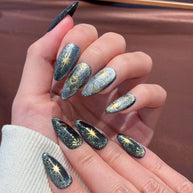 black gold glitter press on nails, celestial sun moon star fake nails, stiletto shape acrylic nails, gothic luxury reusable nails, Halloween party festival nails, 3D gold totem nail art, edgy daily wear fake nails, 2026 trendy gothic nails